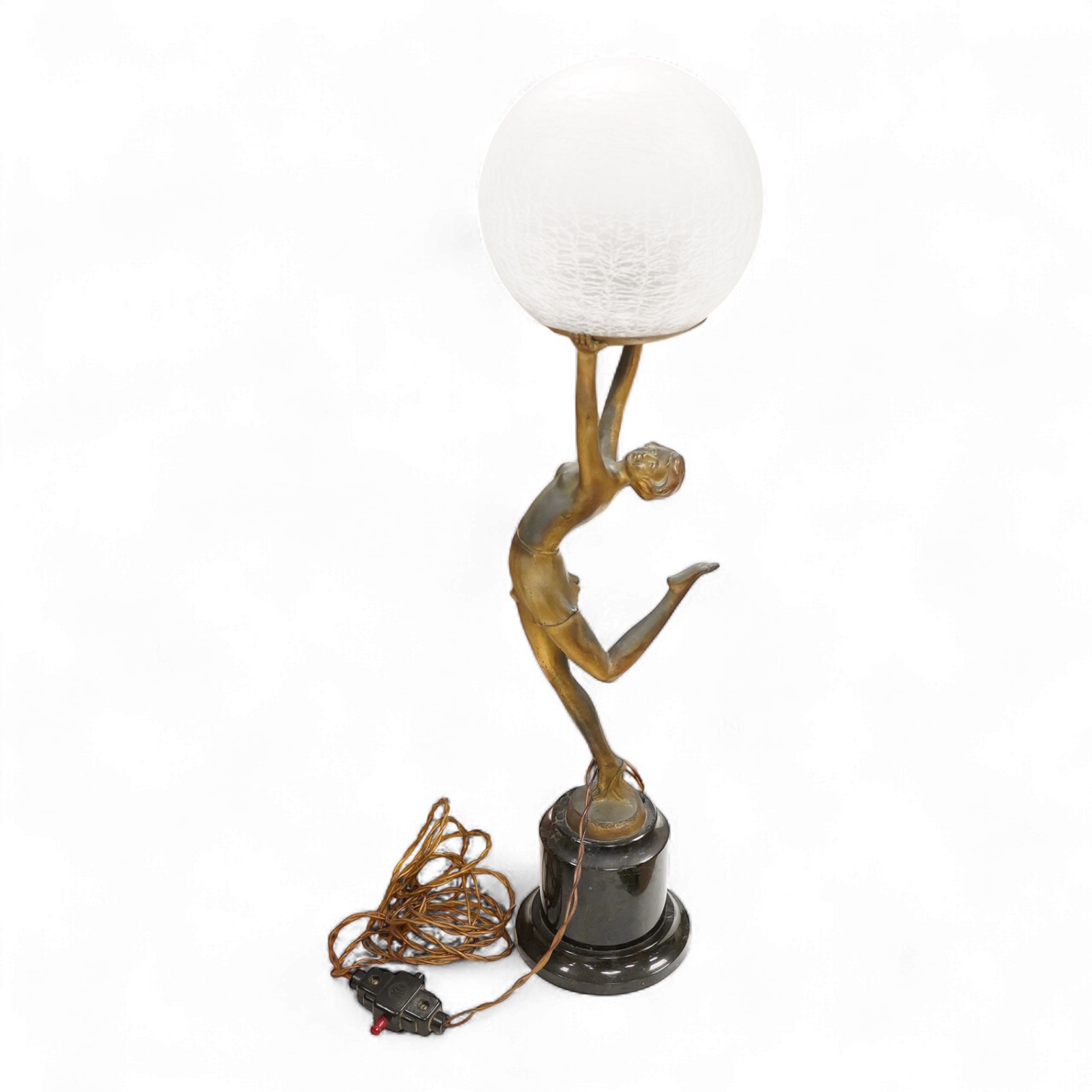 An Art Deco spelter ‘Dancing Girl’ table lamp with a frosted glass globe shade, 57cm high